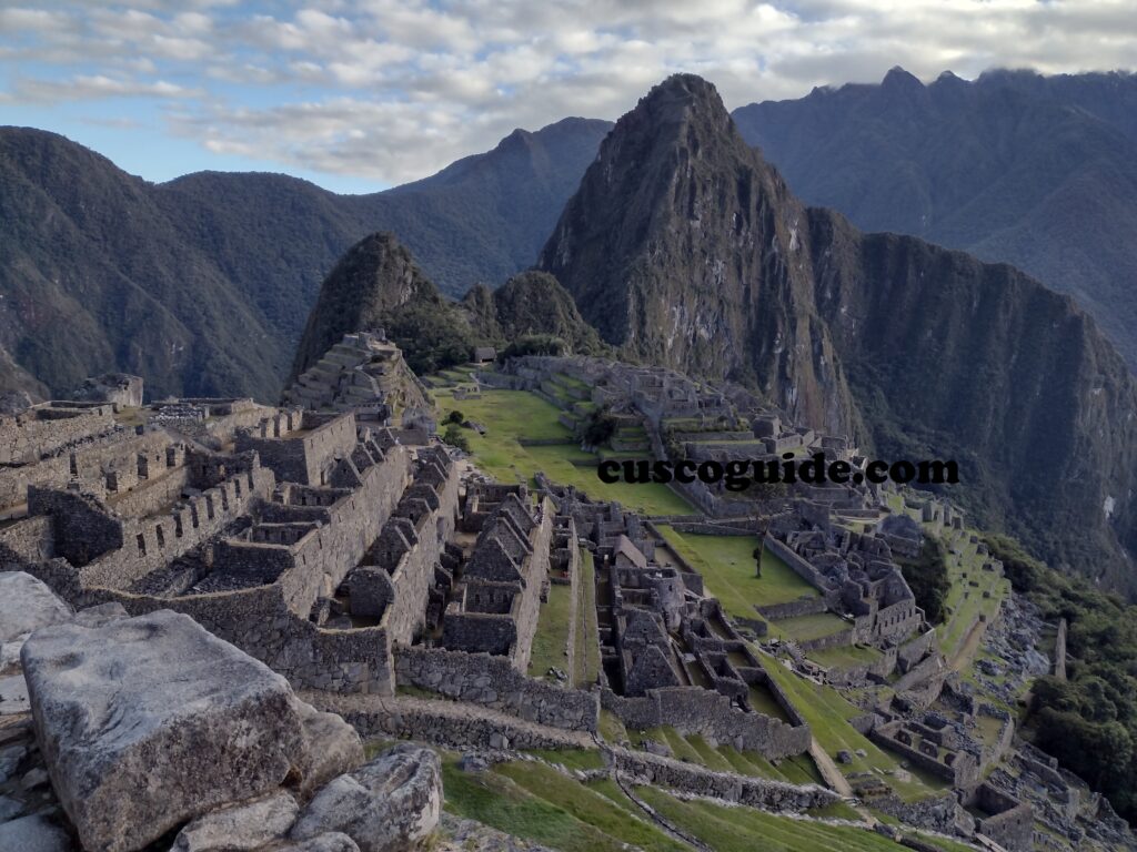 The ancient stone citadel of Machu Picchu, showcasing its terraced fields, temples, and dwellings under the Andean sky.