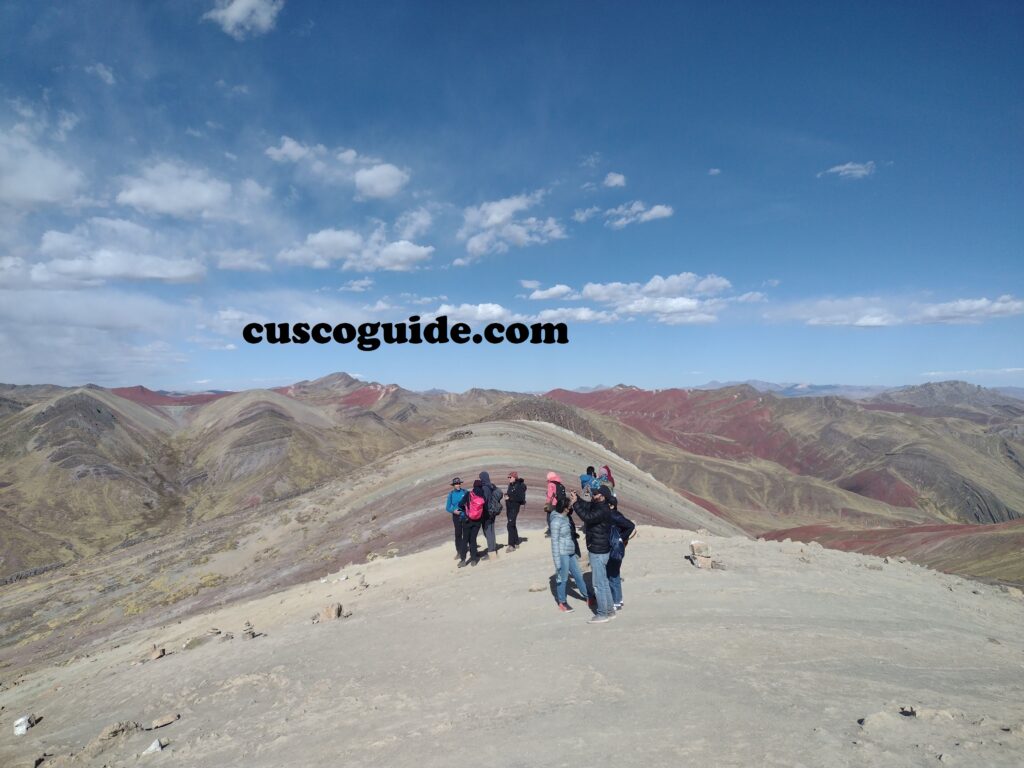 The vibrant striped mountains of Palcoyo Pass, with multiple colorful peaks surrounded by the scenic Andes.